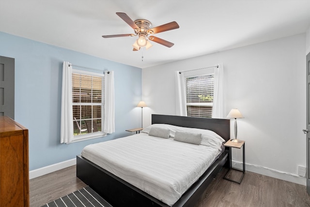 bedroom with hardwood / wood-style floors and ceiling fan