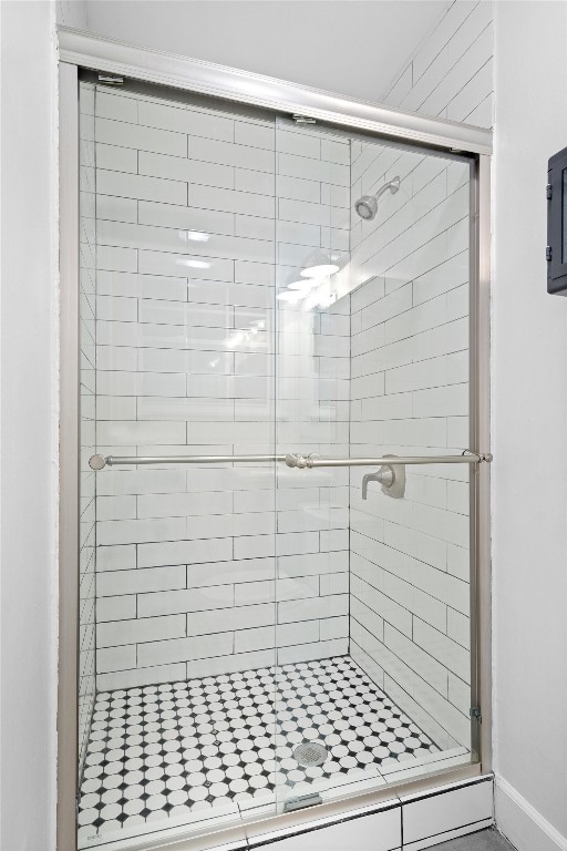 bathroom featuring a shower with shower door