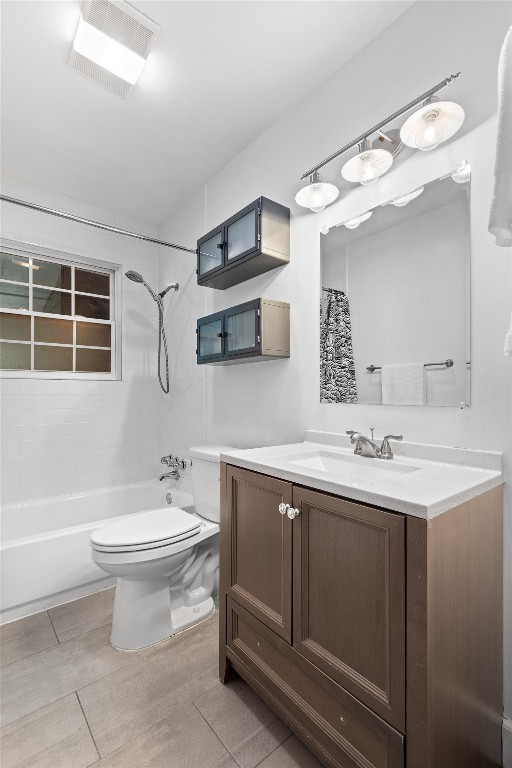 full bathroom featuring vanity, toilet, shower / tub combo with curtain, and tile patterned floors