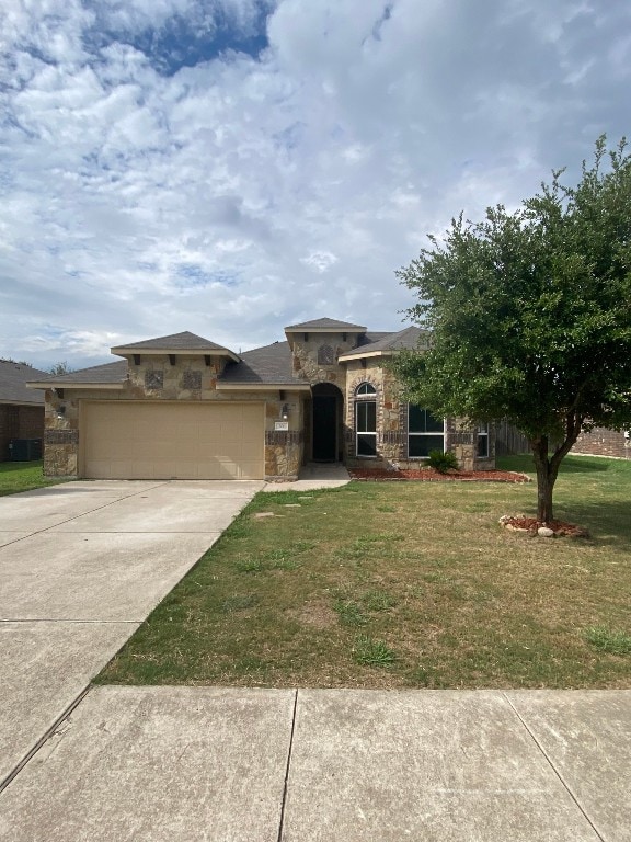 view of front of property with a garage and a front yard