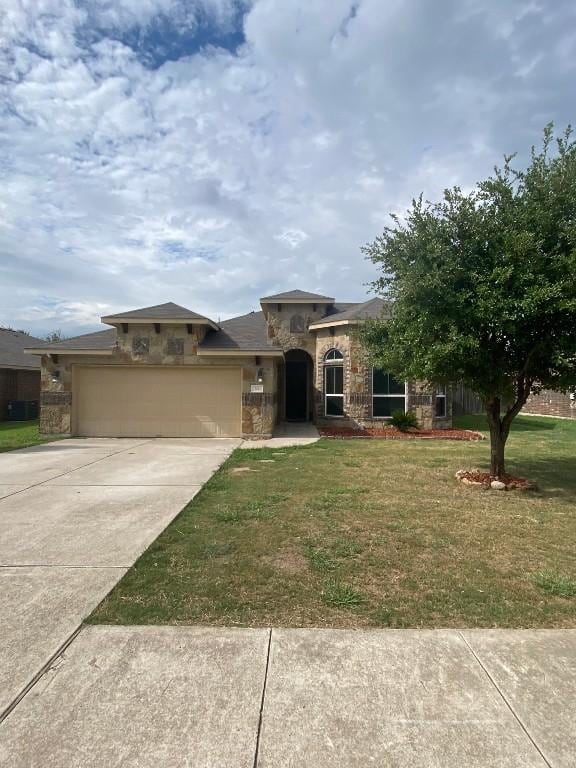 view of front facade with stone siding, a garage, concrete driveway, and a front lawn