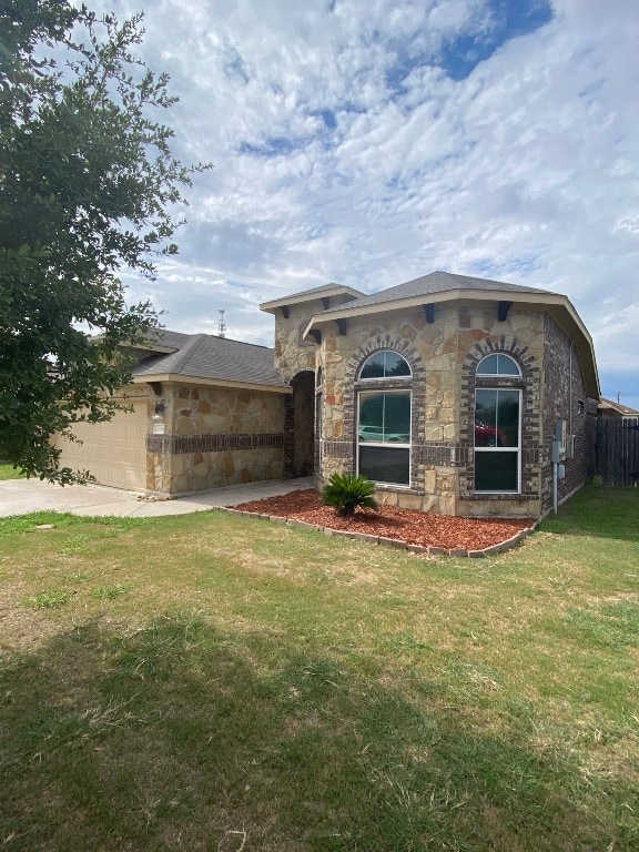 view of home's exterior with a garage and a lawn