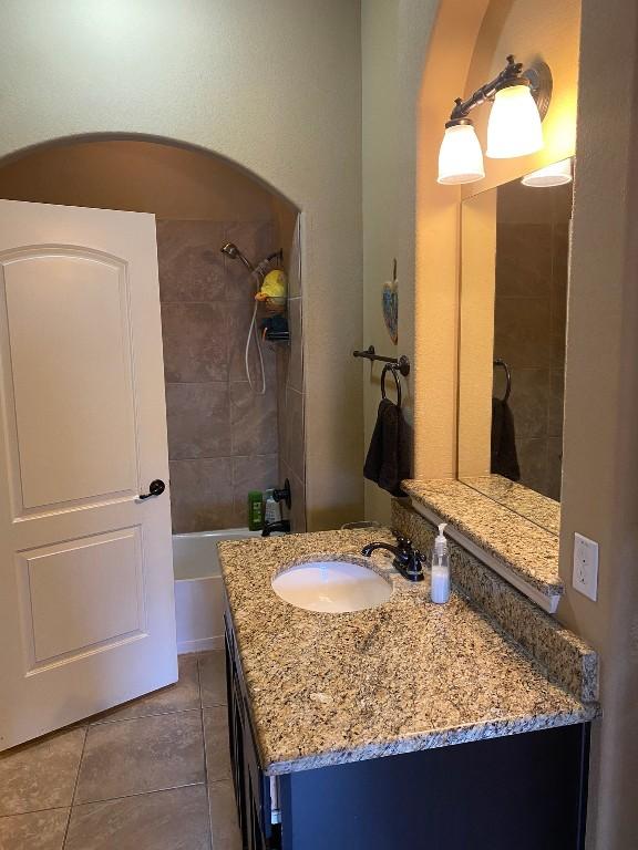 bathroom with tile patterned flooring, vanity, and shower / bath combination