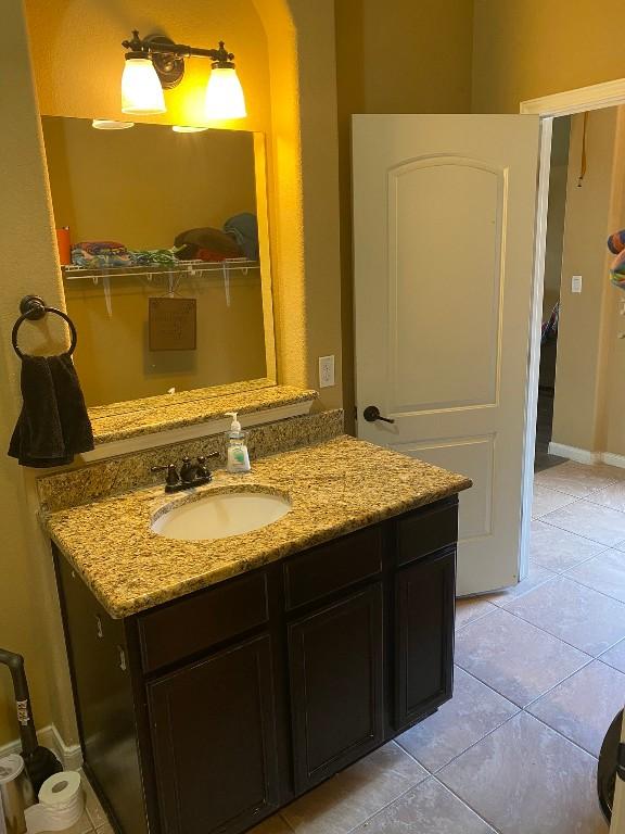 bathroom featuring tile patterned floors, vanity, and baseboards