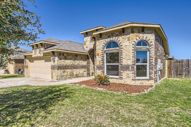 206 Swenson Dr, Hutto, TX 78634 - view of front of house with stone siding, driveway, and a garage