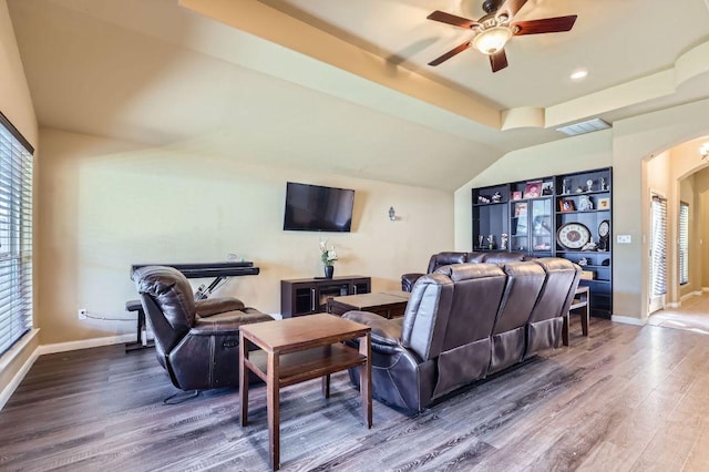 206 Swenson Dr, Hutto, TX 78634 - living room with arched walkways, wood finished floors, a ceiling fan, and vaulted ceiling