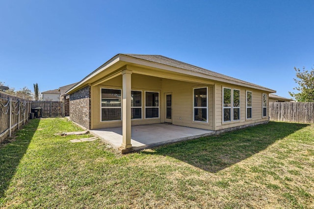 206 Swenson Dr, Hutto, TX 78634 - back of house featuring a fenced backyard and a patio