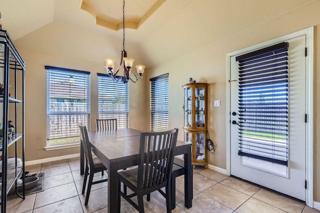 206 Swenson Dr, Hutto, TX 78634 - dining room with a chandelier, light tile patterned flooring, and vaulted ceiling