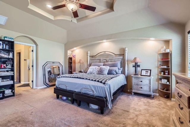 206 Swenson Dr, Hutto, TX 78634 - bedroom with light carpet, a tray ceiling, arched walkways, and a ceiling fan
