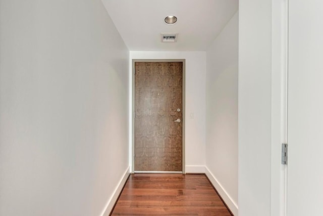 entryway with visible vents, baseboards, and wood finished floors