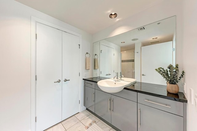 full bathroom with a stall shower, visible vents, marble finish floor, and vanity