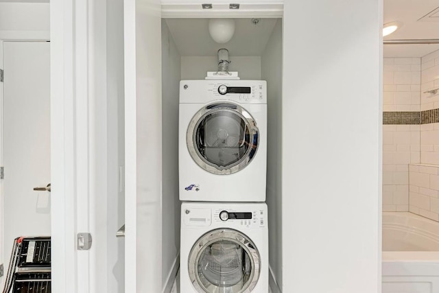 clothes washing area with laundry area and stacked washer / dryer