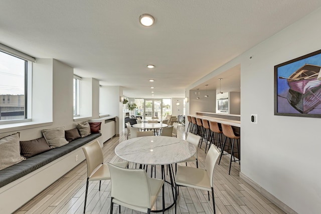 dining area with baseboards, recessed lighting, and wood tiled floor