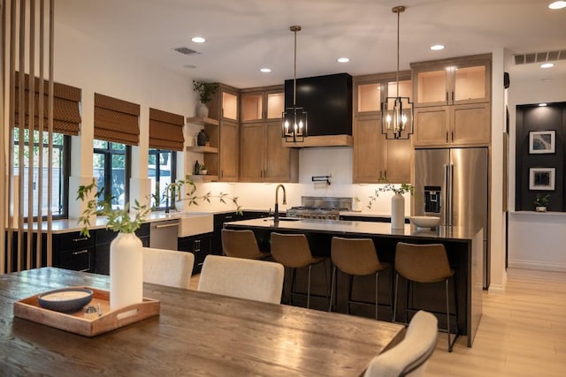 kitchen with pendant lighting, a kitchen island, and a kitchen breakfast bar