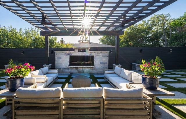 view of patio / terrace featuring a fenced backyard and an outdoor living space with a fireplace