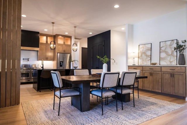 dining space with light wood-style floors, visible vents, and recessed lighting