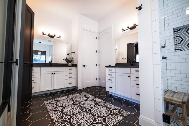 full bathroom featuring tile patterned floors, two vanities, a sink, and tiled shower