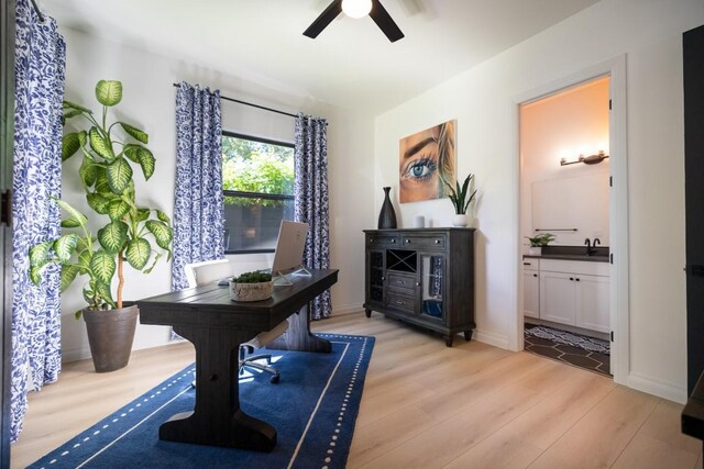 office area with light wood-type flooring and ceiling fan