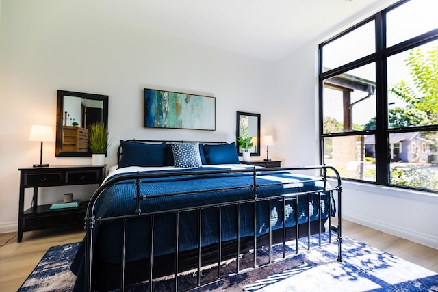 bedroom featuring light wood-style flooring and baseboards