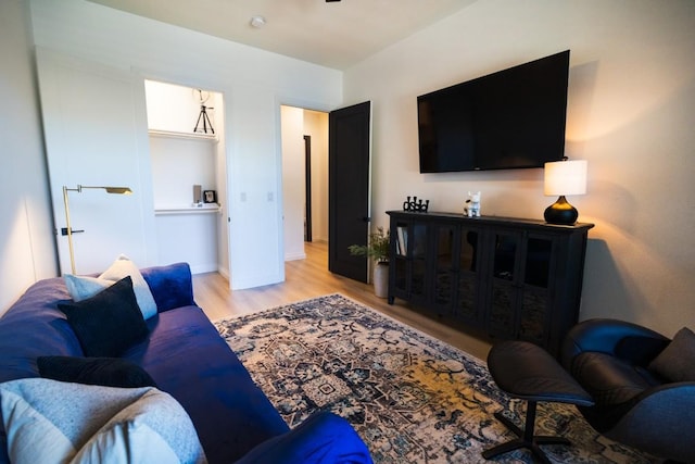 living area featuring baseboards and wood finished floors