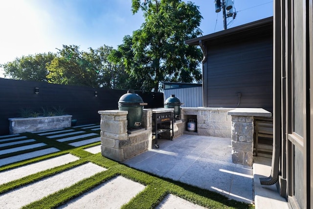 view of patio with a grill and fence