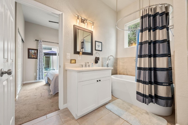 103 Hans Bell Dr, Blanco, TX 78606 - ensuite bathroom featuring vanity, tile patterned flooring, and shower / bath combo with shower curtain