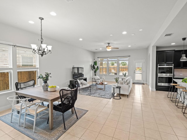 dining space featuring ceiling fan with notable chandelier and light tile patterned floors