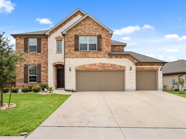 view of front of property featuring a garage and a front yard