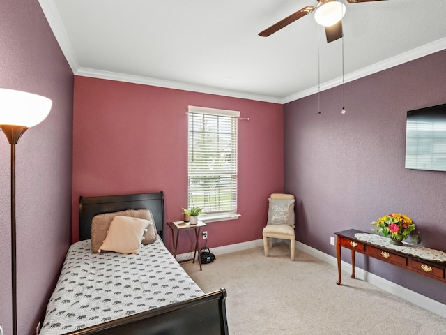 carpeted bedroom with crown molding and ceiling fan