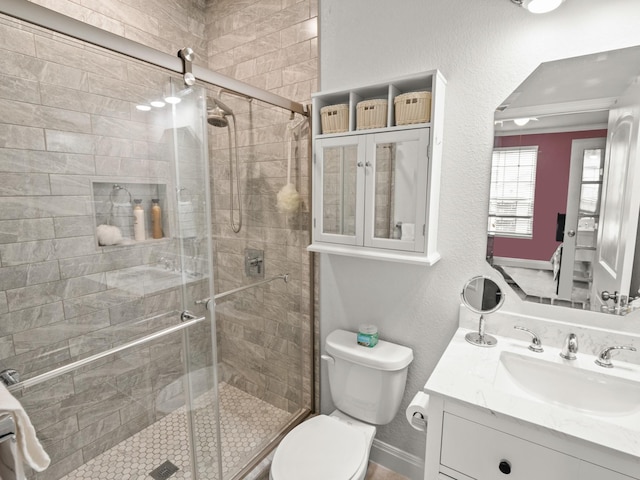 bathroom with vanity, toilet, and walk in shower