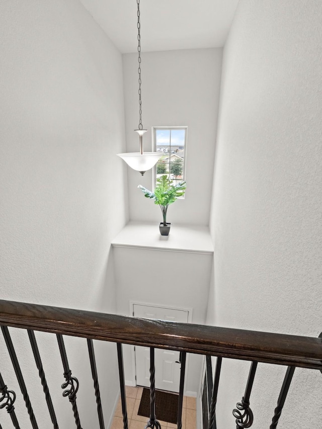 stairs with tile patterned floors