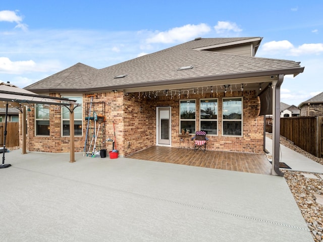 back of property featuring a gazebo and a patio area