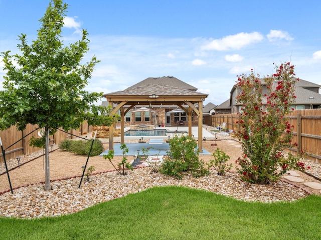 view of yard with a fenced in pool, a gazebo, and a patio