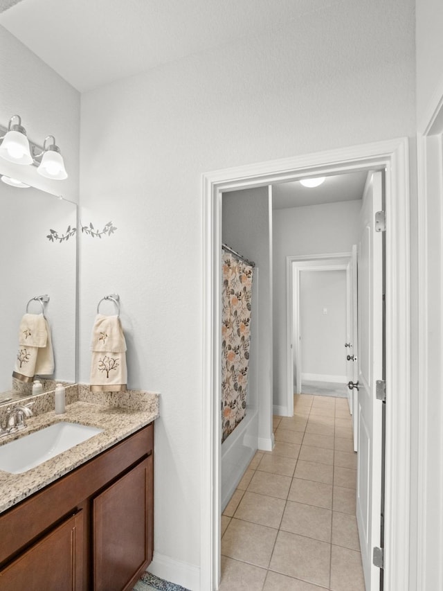 bathroom with tile patterned flooring, vanity, and shower / bath combination with curtain