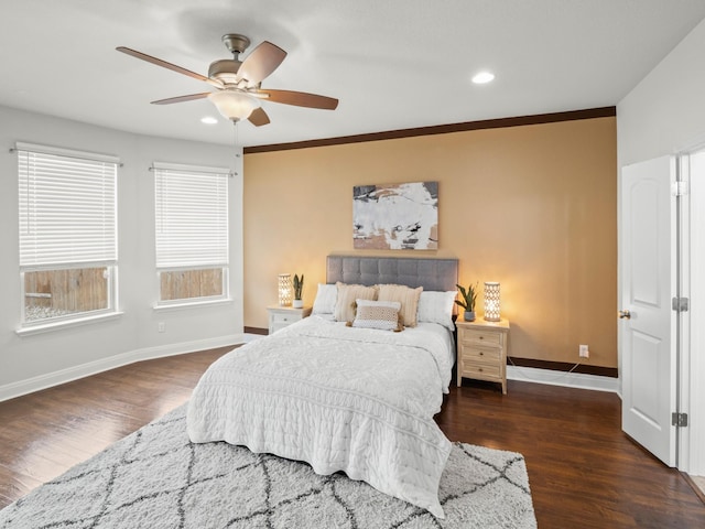 bedroom with dark wood-type flooring, ceiling fan, and crown molding