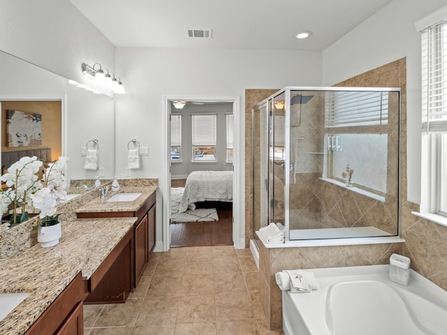 bathroom featuring plus walk in shower, tile patterned floors, and vanity