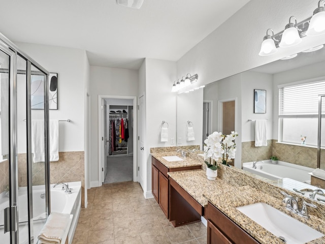 bathroom featuring plus walk in shower, tile patterned floors, and vanity