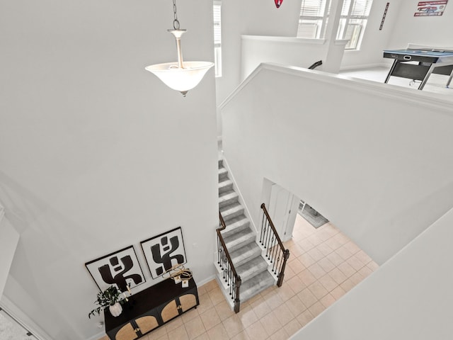 stairway with tile patterned floors