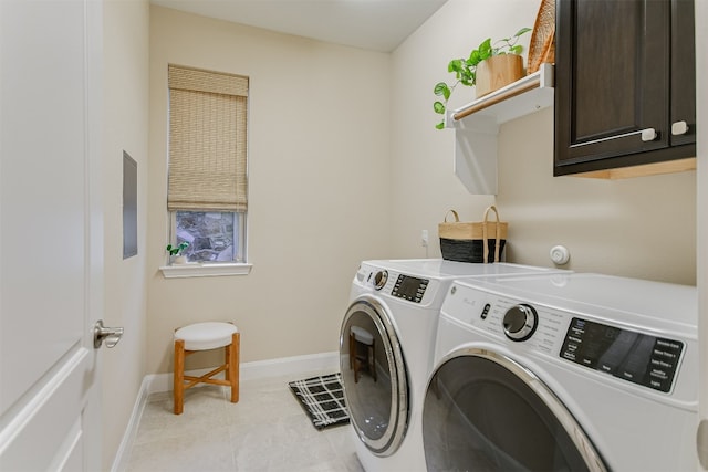 washroom featuring washer and dryer, cabinet space, baseboards, and light tile patterned floors