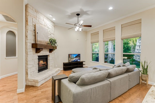 203 Maxwell Way, Austin, TX 78738 - living room with crown molding, a ceiling fan, light wood finished floors, a fireplace, and recessed lighting