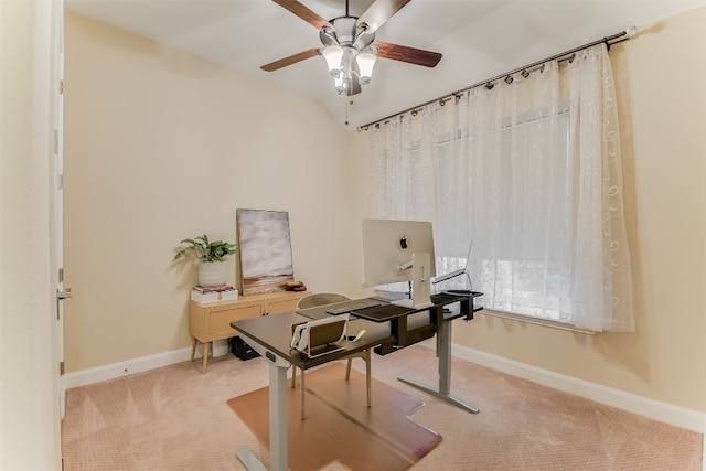 carpeted home office featuring vaulted ceiling, ceiling fan, and baseboards