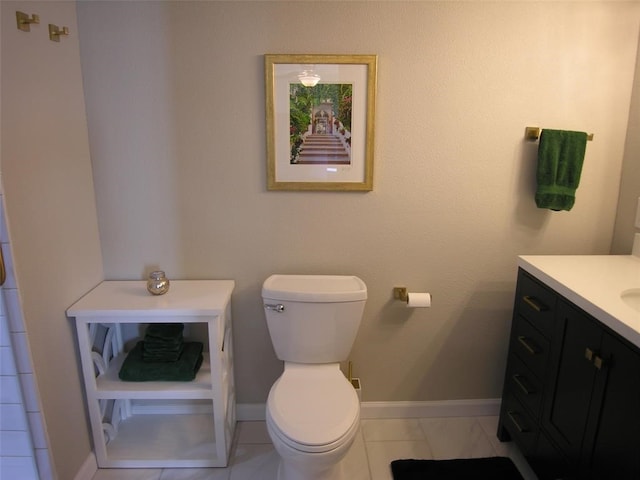 bathroom featuring tile patterned flooring, vanity, and toilet