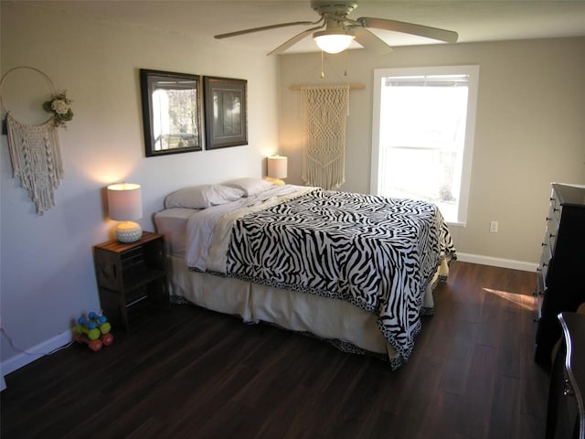 bedroom featuring dark wood-type flooring, ceiling fan, and multiple windows