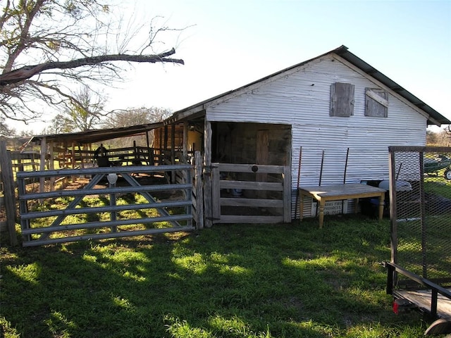 back of house with an outbuilding