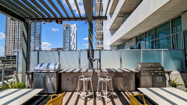 view of patio with a grill and a pergola