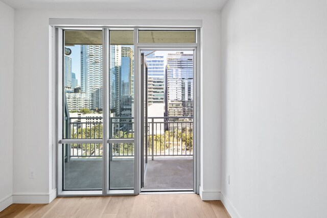 222 W Ave Unit 1503, Austin, TX 78701 - entryway featuring wood finished floors, baseboards, and a view of city