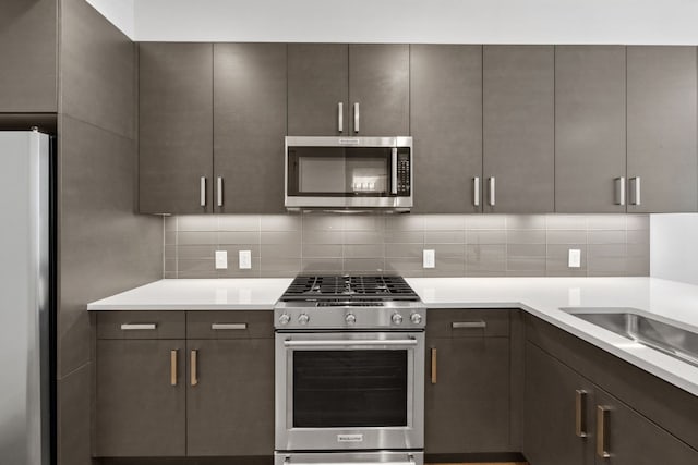 kitchen with decorative backsplash and appliances with stainless steel finishes