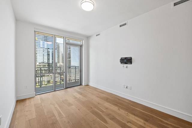 spare room featuring light wood-type flooring