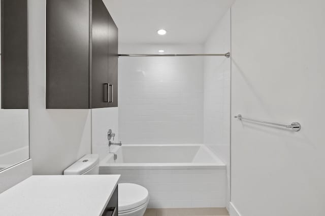 full bathroom with vanity, tiled shower / bath combo, and toilet