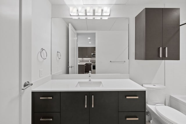 bathroom featuring a bath, vanity, and toilet